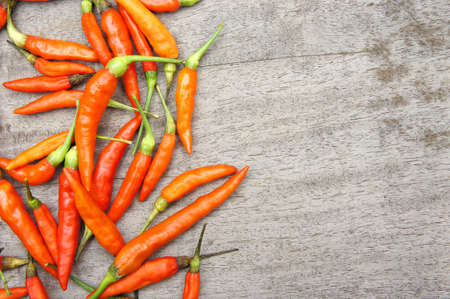 The red chili on wooden background , cooking styleの写真素材