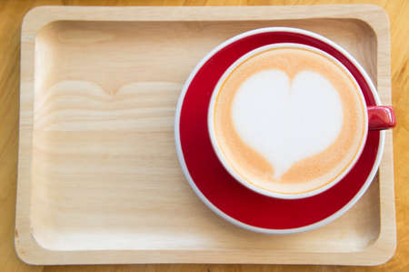 Heart coffee cup milk in a coffee shop , Delicious coffee cakeの写真素材