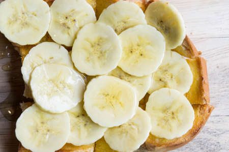 toast banana with honey caramal on table woodの写真素材