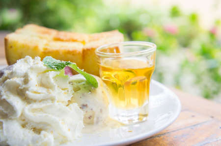 ice cream honey toast and whipped cream on the tableの写真素材