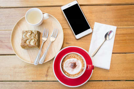 coffee red cup on wood table in cafeの写真素材