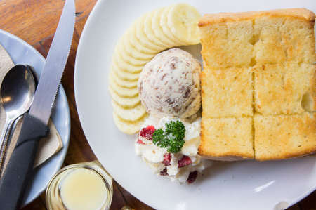 Toast and ice cream and banana dessert in cafeの写真素材