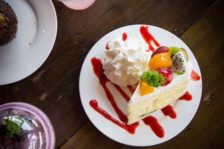 fruit cake muffin dessert and sweet beverage in cafeの写真素材