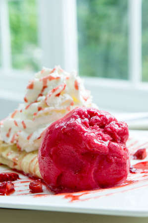 ice cream strawberry crepe dessert on white dishの写真素材