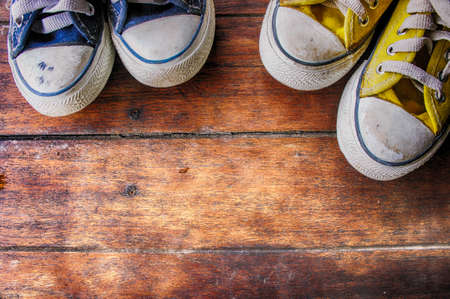 Sneakers on wooden floor , dirty convas shoe on old wood