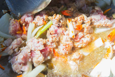 Basil Fried Pork Chops Cooking on a hot panの写真素材