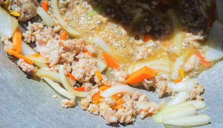 Basil Fried Pork Chops Cooking on a hot panの写真素材