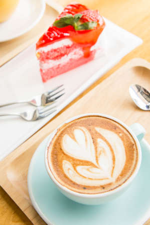 coffee heart cup and cake on wood table in coffe shop cafeの写真素材