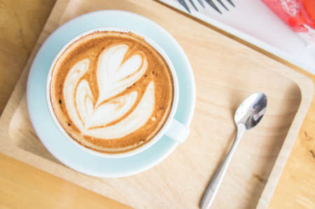 coffee heart cup and cake on wood table in coffe shop cafeの写真素材