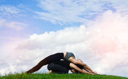 Woman practicing  yoga relax in nature and blue sky background