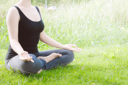 Young woman practicing yoga Everyday Yoga helps in concentration, breath, shape body, strength, help skin brighten. Among the Dharma Air in bright daysの写真素材