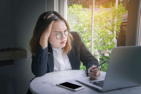 working woman , young business woman asian style busy and Stressful job There are problems in the work not thought out, resulting in unsuccessful workの写真素材