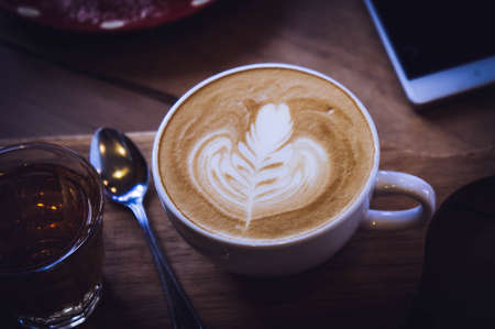 coffee cup and tasty cake on wood table and Blank paper waiting for ideas , coffee time work