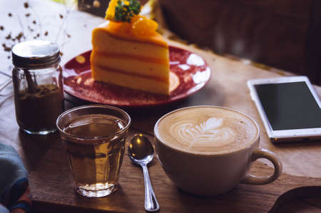 Latte aroma coffee And delicious cake at leisure, coffee time in cafeの写真素材