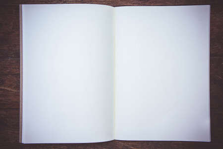 Blank Paper Book On the wood working table Wait for creative time to start , paper work for text and copy spaceの写真素材
