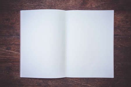 Blank Paper Book On the wood working table Wait for creative time to start , paper blank for text backgroundの写真素材