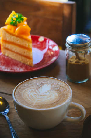 Coffee cup and tasty cake on wood table and Blank paper waiting for ideasの写真素材