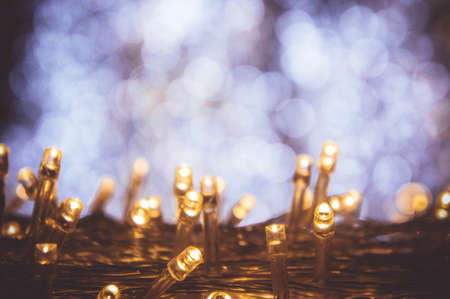 The night light bokeh festival with small LED light decor on party night Christmas or new year backgroundの写真素材