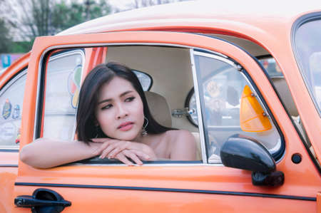 Pretty girl inside antique carの写真素材