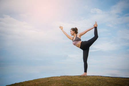 yoga girl In the morning time on blue sky background Strengthen the concentration of skin, health and good health is a good exerciseの写真素材