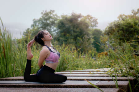 yoga practice in the morning. Women exercise, inhale the sun, create concentration and shape , Yoga and natureの写真素材