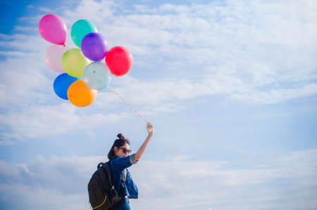 Girl holds the balloons in the park