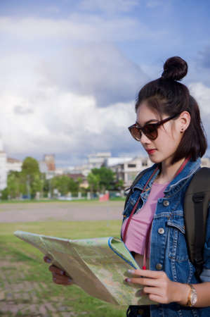 traveler girl holds the map and looks for destination