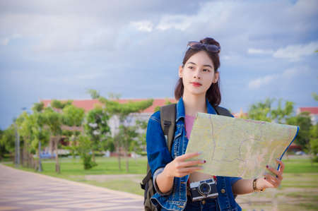 Female tourists Looking for destinations on the map in the town