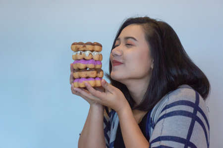 happy woman eating donut , she love donut dessert , fat girl's enjoy eating