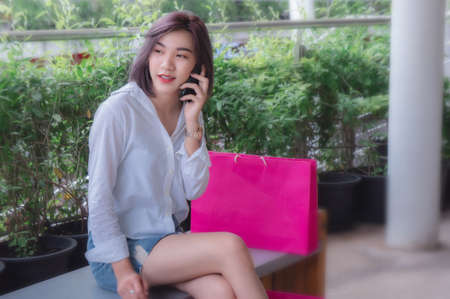happy girl's smiling and using telephone mobile , talking smart phone on the nice day