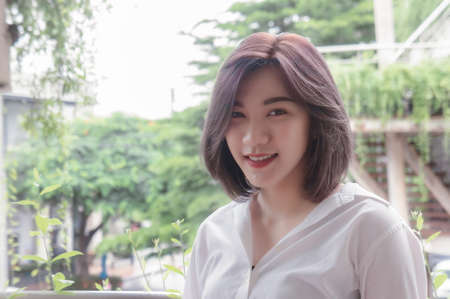 Asian girl's short hair smiling and looking emotion in the nature garden