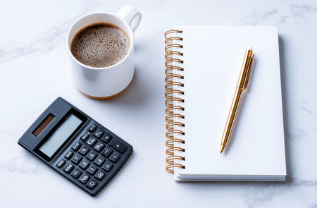 Pen, calculator, notebook and cup of coffee on white marble backgroundの素材