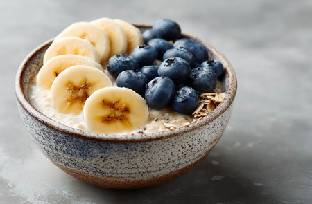 Oatmeal with blueberries and banana in bowl on table, closeupの素材