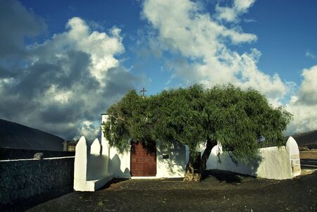 a lonely white church in rough lava desert, lanzarote, canary islandの写真素材