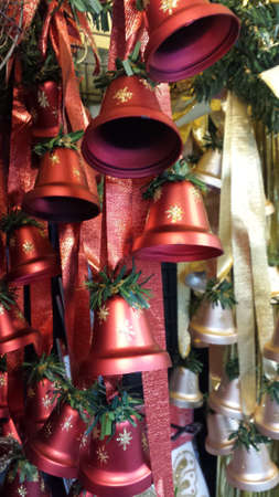 Christmas red and gold bells on a ribbonの写真素材