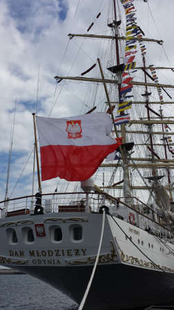Gdynia, Poland - May 03, 2017: Large Polish flag waving on the sailboat Dar Youth on a cloudy dayのeditorial素材