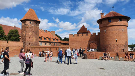 Malbork, Poland - June 25, 2020: Tourists are visiting the Teutonic Castle in Malbork, Poland