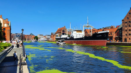 Gdansk, Poland - July 11, 2021: View of the old city of Gdansk on the Motlawa River. Tourists walk...