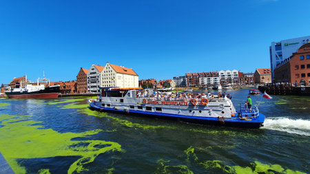 Gdansk, Poland - July 11, 2021: View of the old city of Gdansk on the Motlawa River. Tourists walk...