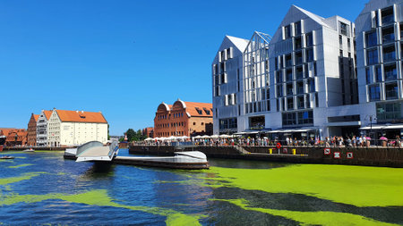 Gdansk, Poland - July 11, 2021: View of the old city of Gdansk on the Motlawa River. Tourists walk...