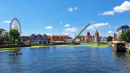 Gdansk, Poland - July 11, 2021: View of the old city of Gdansk on the Motlawa River. Tourists walk...