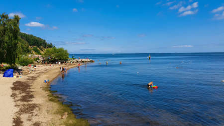 Gdynia, Poland - July 18, 2021: People are resting on the beach on a sunny day in Gdynia Orlowo, Polandのeditorial素材