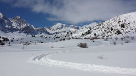 sled markings on snowy mountainの写真素材