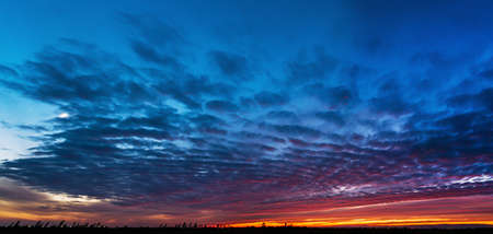 Natural Sunset. Bright Dramatic Sky And Dark Ground. Landscape Under Scenic Colorful Sky. Sun Over Skyline, Horizon. Transcarpathia and Uzhhorod. Magic Sunset. Dusk. Clouds. Panoramaの写真素材