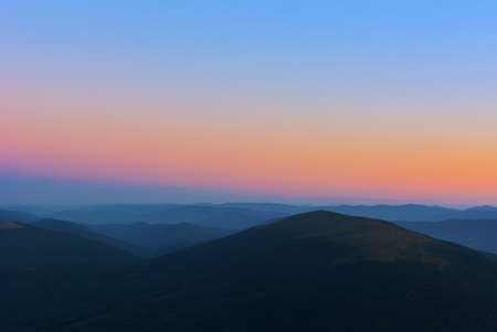 The first or last rays of the sun on a mountain pass. Morning and evening in nature. Colorful sunset...