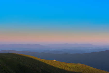 The first or last rays of the sun on a mountain pass. Morning and evening in nature. Colorful sunset...
