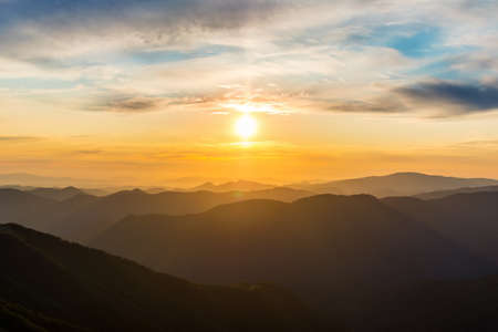The first or last rays of the sun on a mountain pass. Morning and evening in nature. Colorful sunset and sunrise over the mountain hills. Carpathians in summer and autumnの販売画像