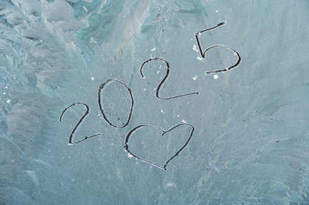 The inscription on the windshield of the car. The car is covered with snow and a crust of ice. Winter, danger, safety, insurance, winter tires. Cold weather outside. Ice texture.の写真素材