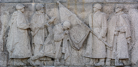 Stone relief depicting Red Army soldiers with flag at Slavin War Memorial in Bratislava, Slovakia, commemorating WWII liberation.の写真素材