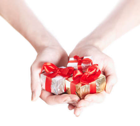 Three small gifts boxes in beautifull girl's handsの写真素材